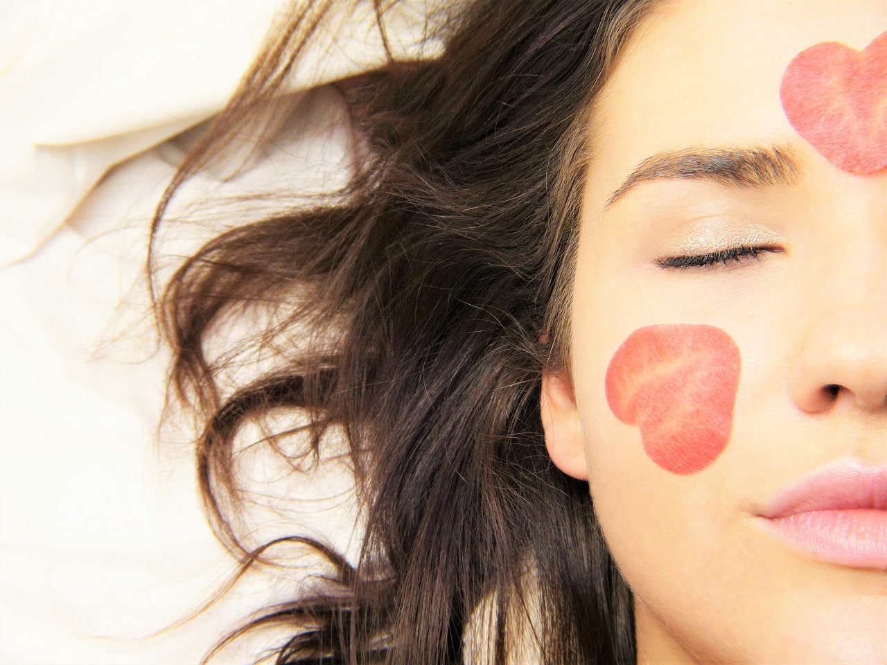 womans's face with two hearts stamped on the skin