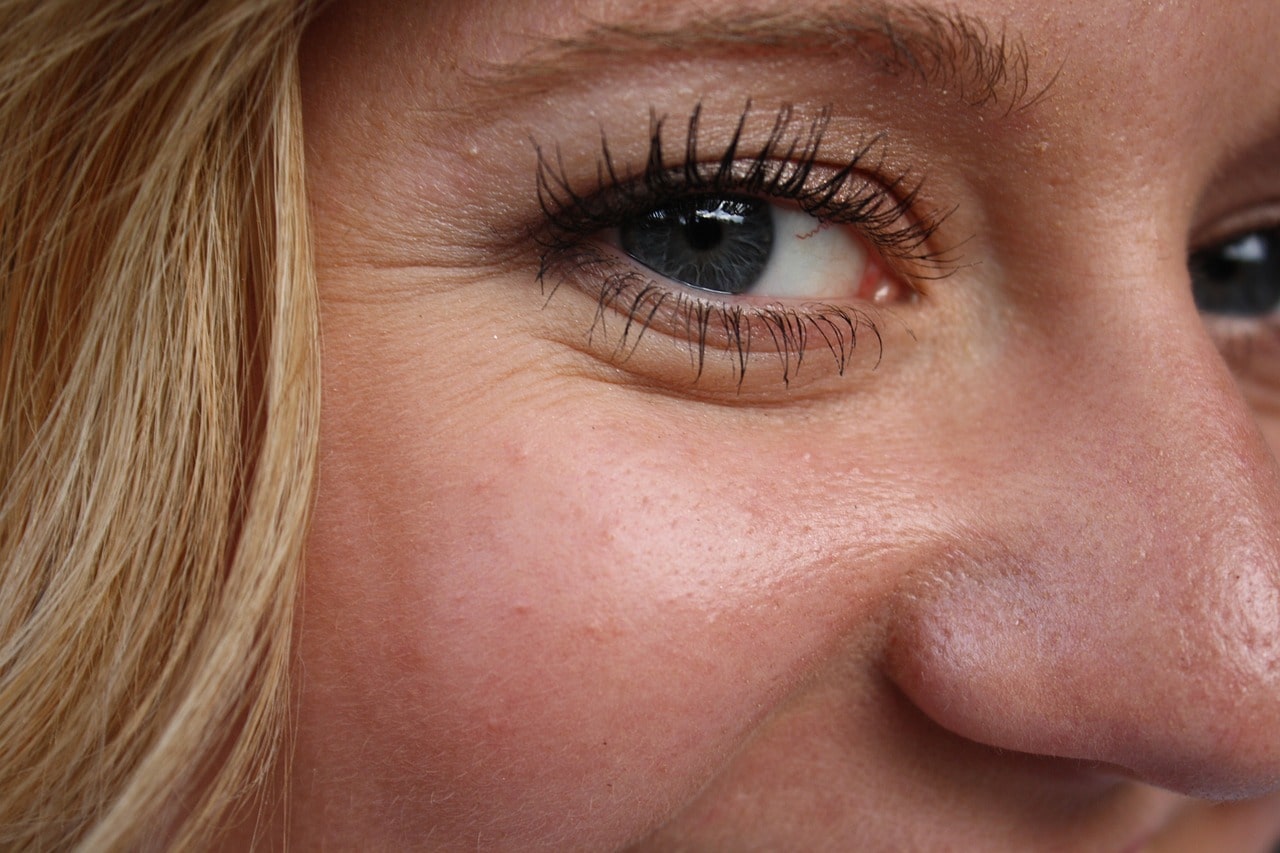 a woman with wrinkles around the eyes