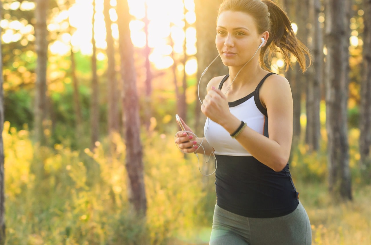 a woman running in the park in sunny weather