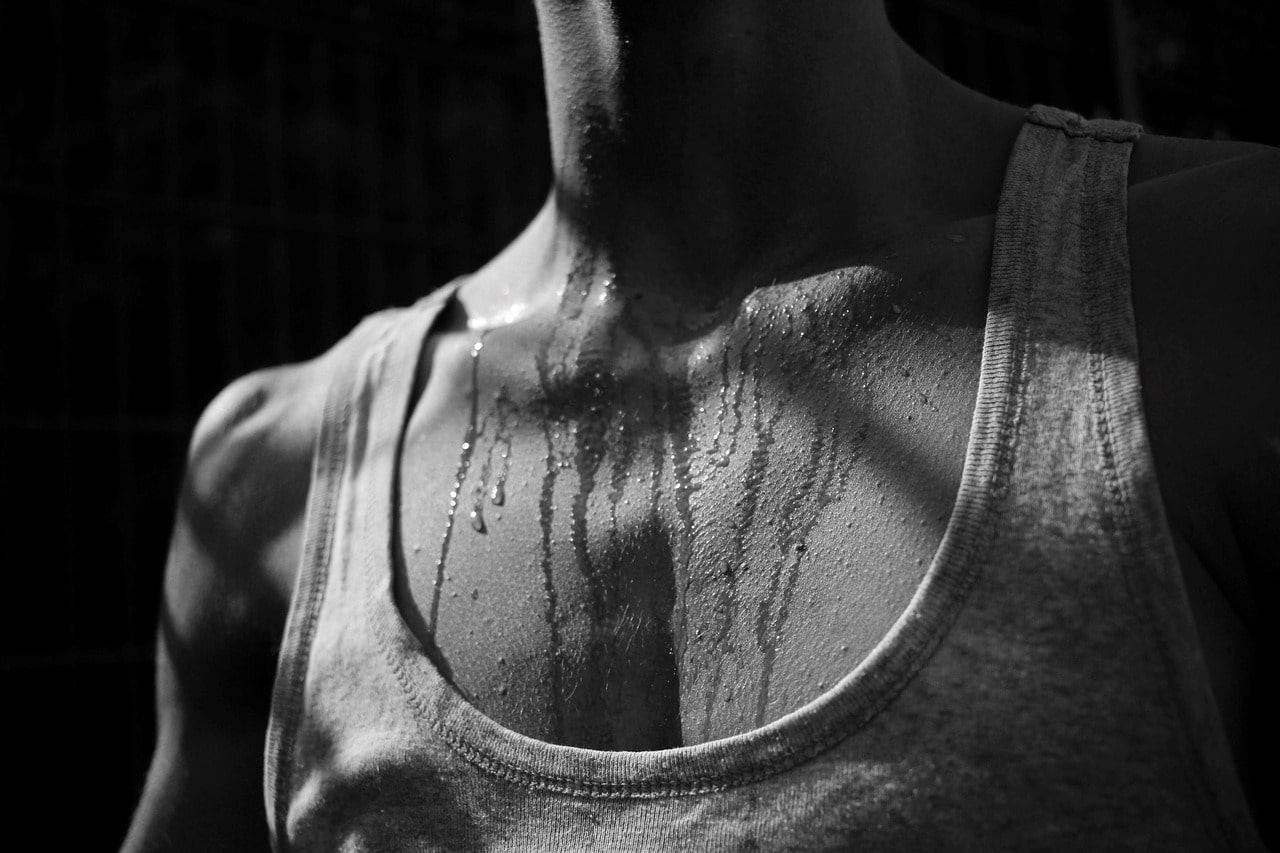 a man with sweat on his chest