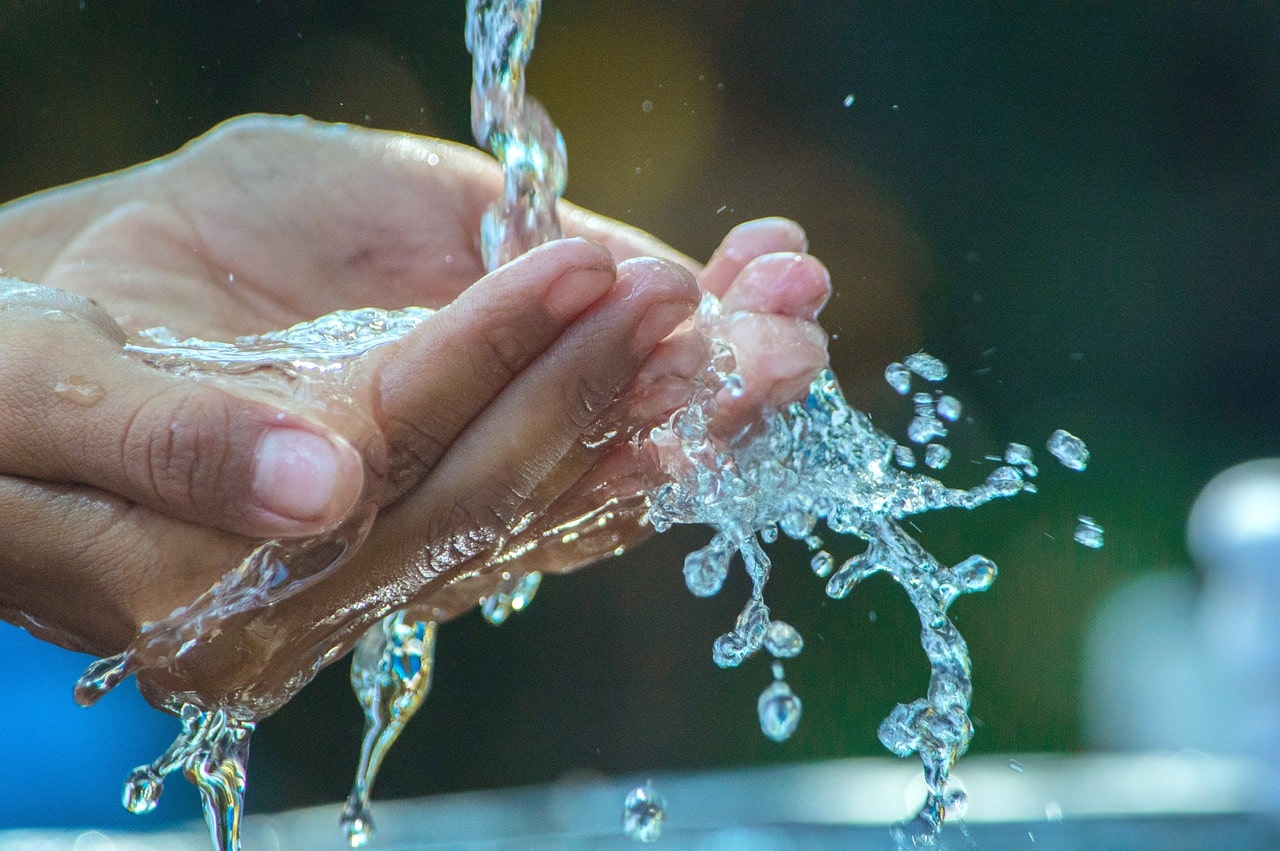 washing hand under running water