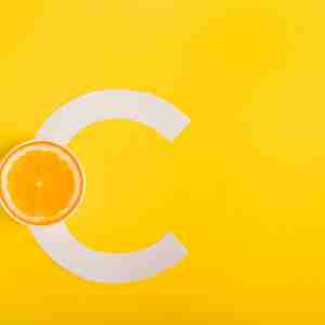 a lemon and a letter "c", depicting vitamin c