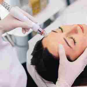 a dermatologist is performing a cosmetic procedure on a woman's face