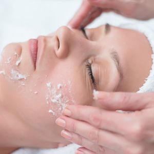 a woman's face being exfoliated