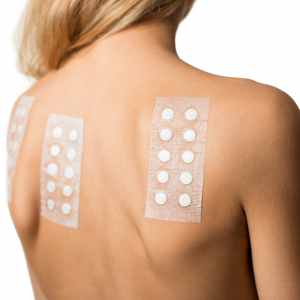 a woman has patches on her back